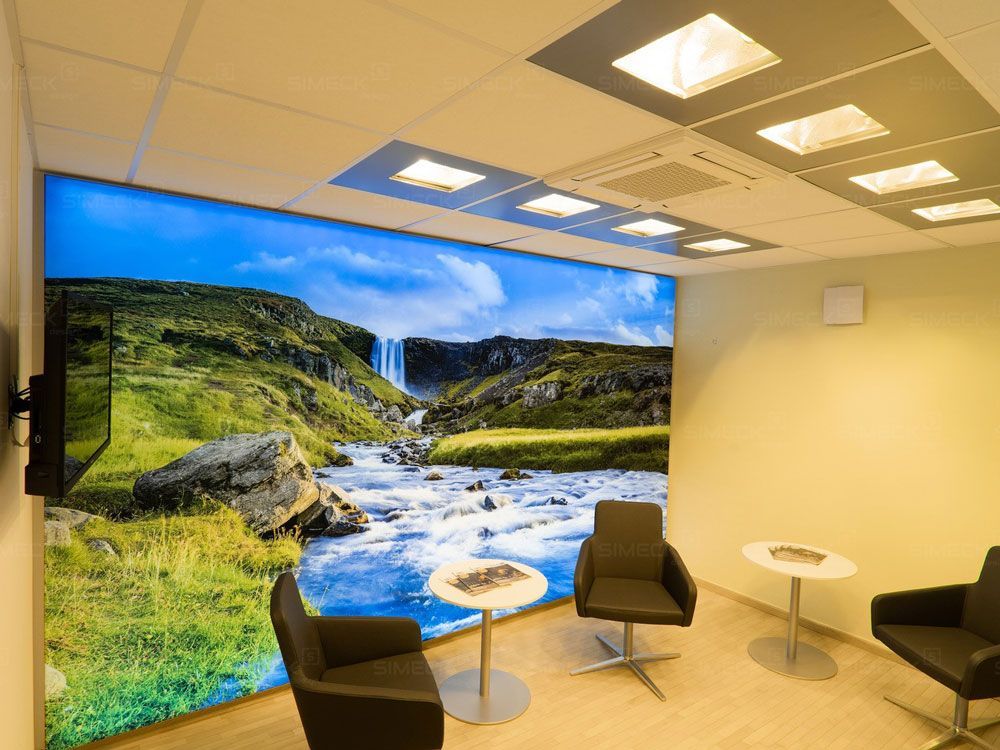 Ein Raum mit Stühlen und Tischen und einem großen Bild eines Wasserfalls an der Wand.