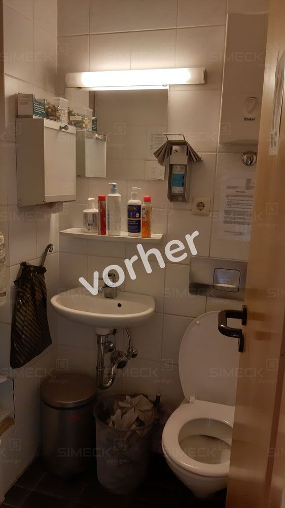 Ein Badezimmer mit Waschbecken, Toilette und Spiegel.