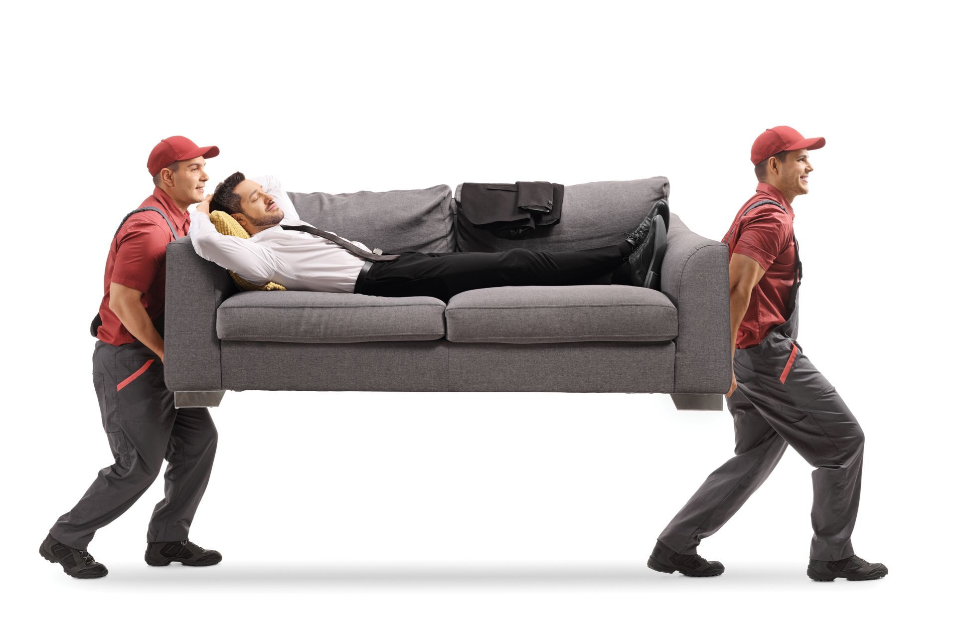 Zwei Umzugshelfer einer Umzugsfirma in Schlieren tragen ein Sofa, auf dem ein Mann entspannt liegt. Zwei Umzugshelfer einer Umzugsfirma in Schlieren tragen ein Sofa, auf dem ein Mann entspannt liegt.