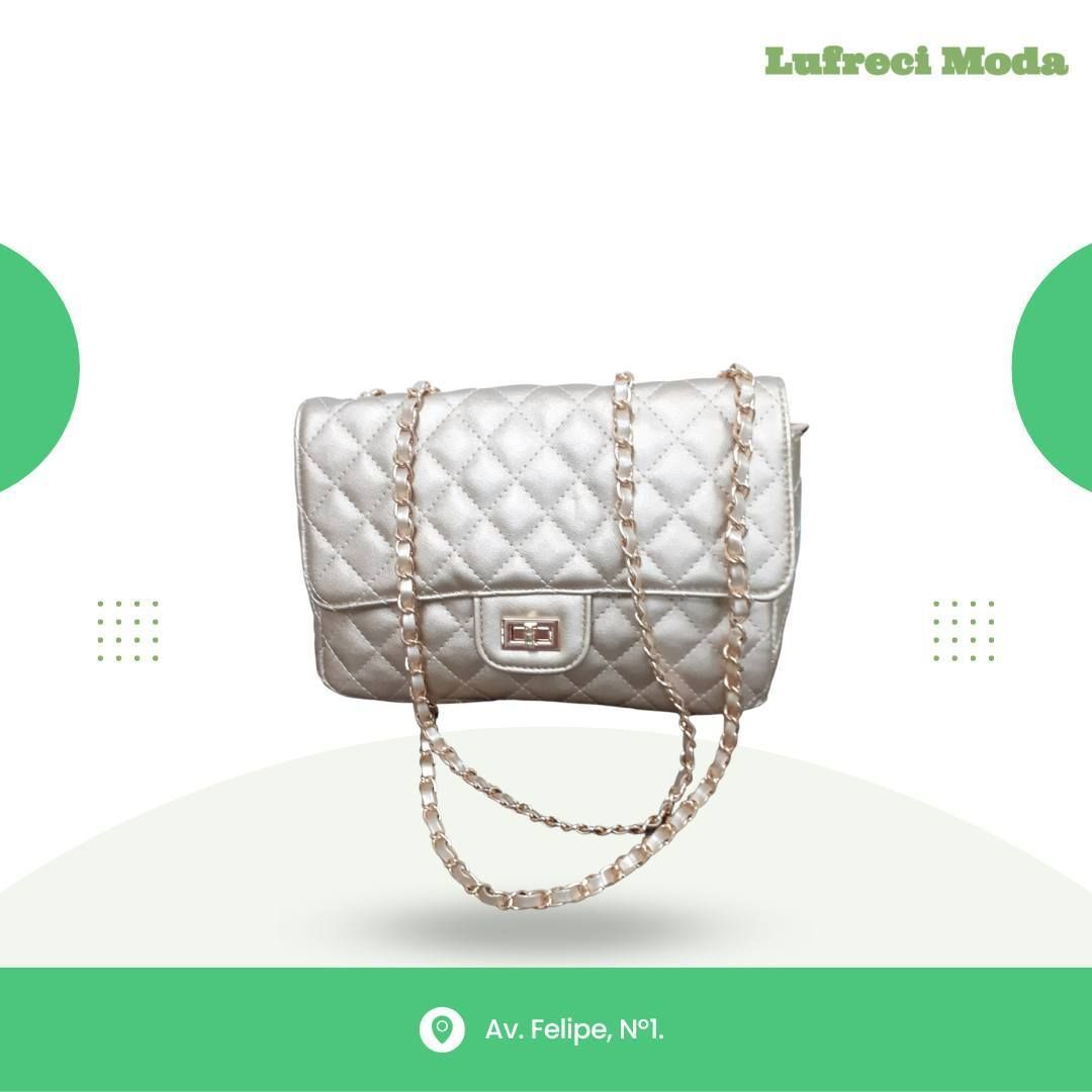 Un bolso plateado acolchado con una correa de cadena dorada centrada en un fondo gráfico blanco y verde para Lufreci Moda.