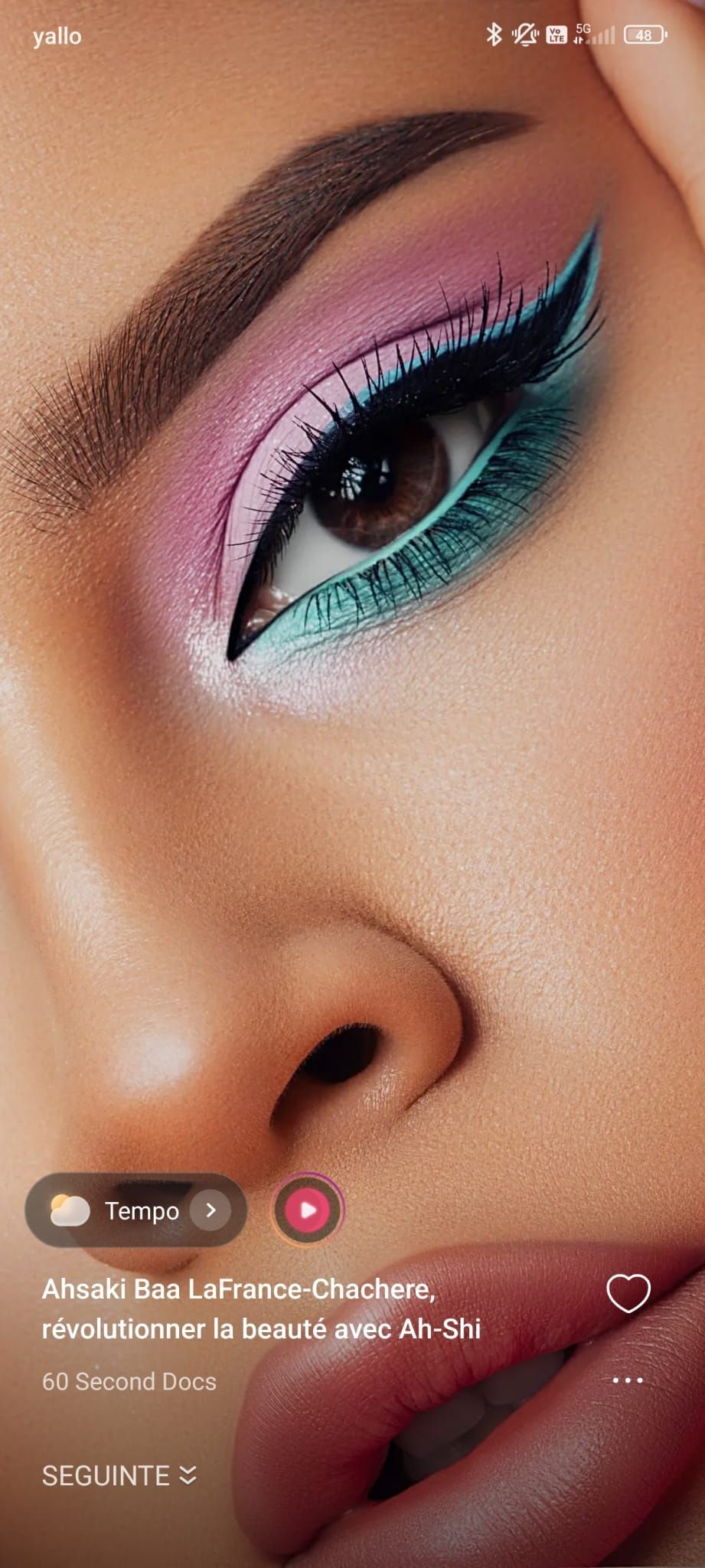 Gros plan sur un œil maquillé de fards à paupières colorés. Maquillage avec eye-liner turquoise, rose et noir.