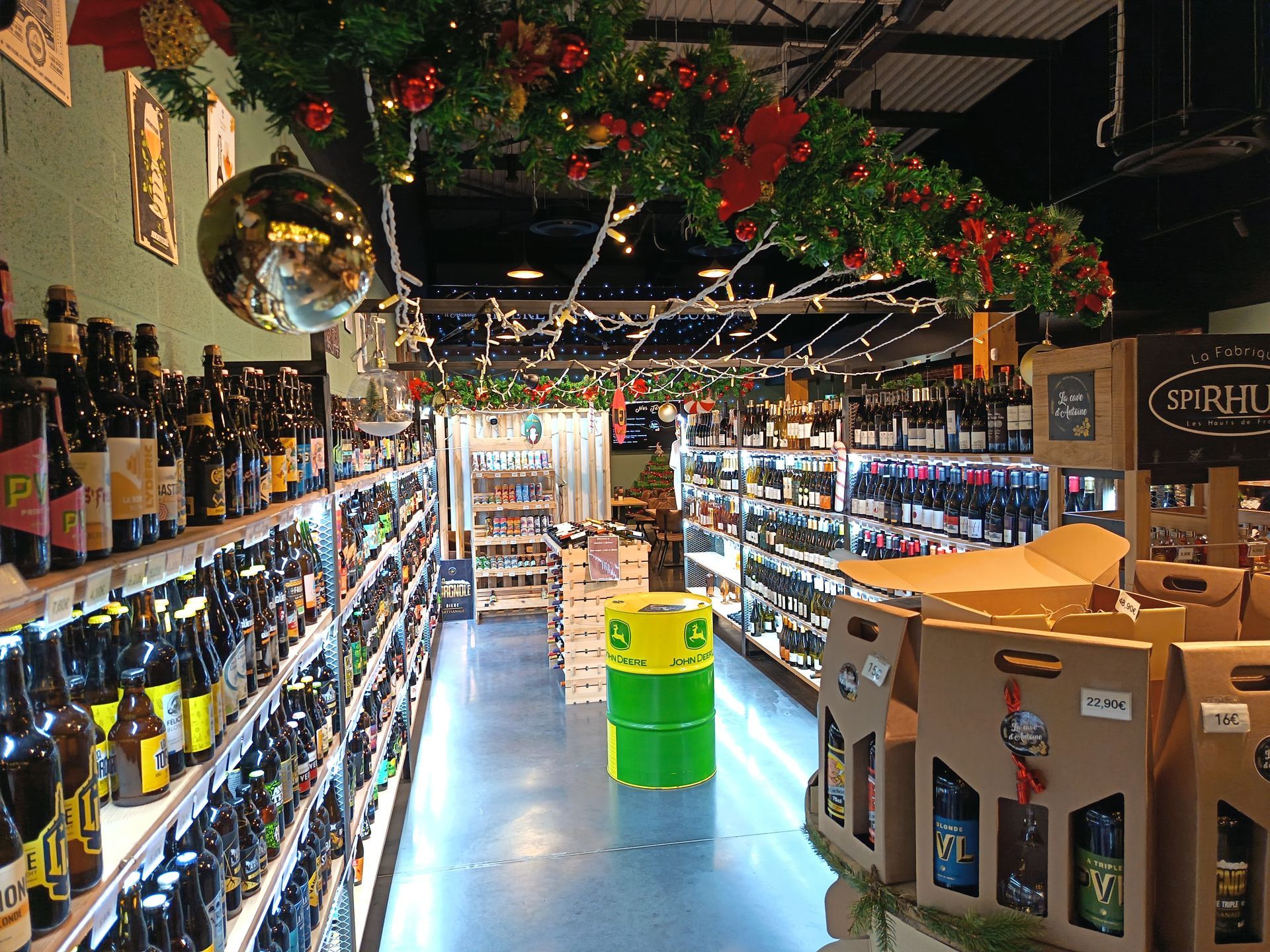 Intérieur de la Cave d'Antoine, bouteilles sur des étagères, décorations de Noël au plafond.