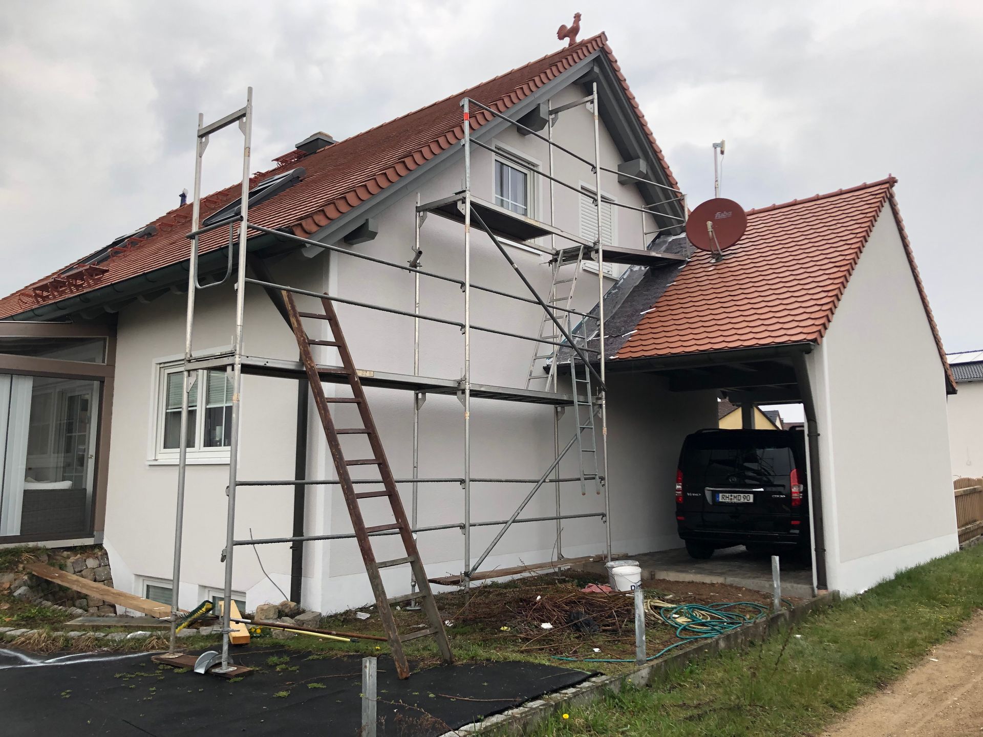 Wohnhaus mit Gerüst vor dem Anbau eines Carports an der Hausseite