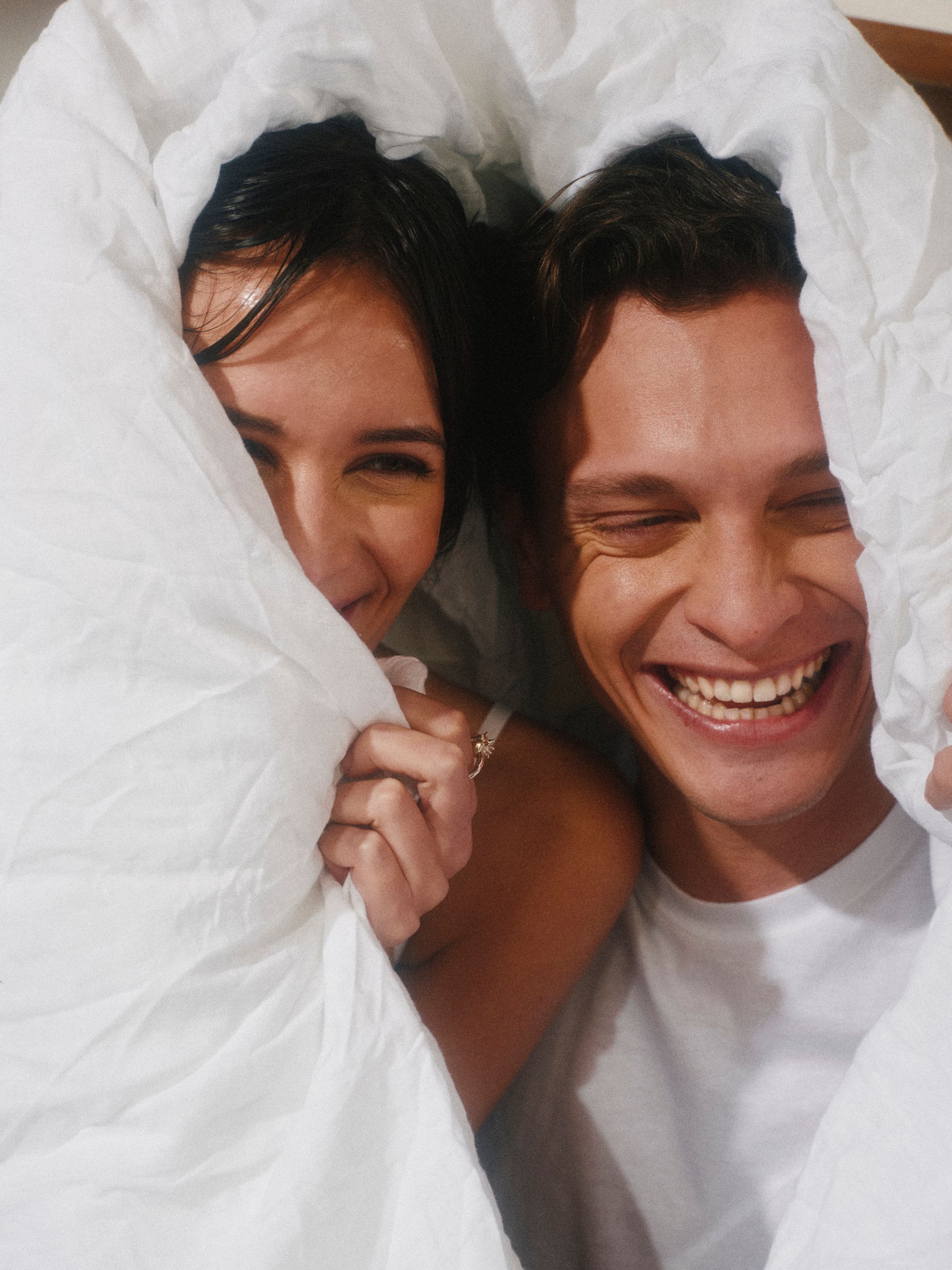 Couple tucked in duvet