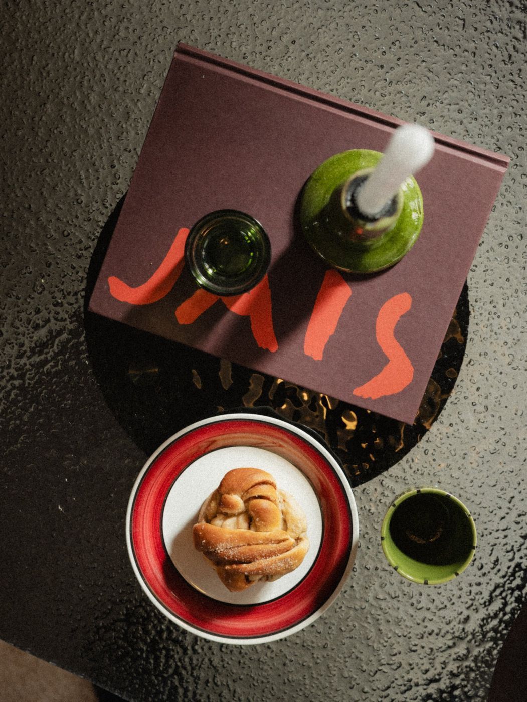 A cinnamon bun on a plate, seen from above