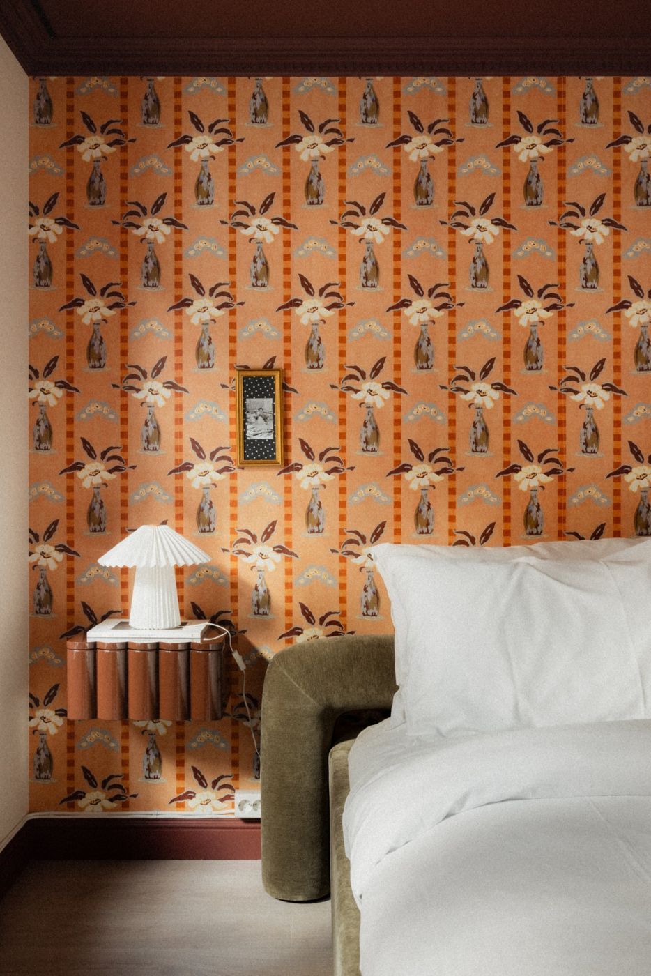 Placeholder: bed against floral wallpaper