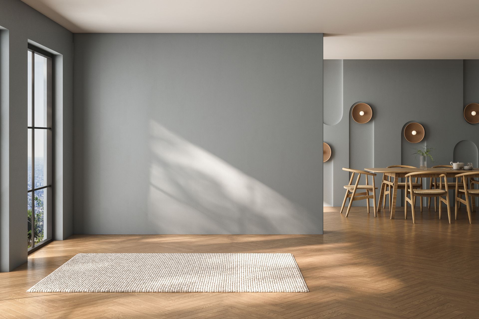 Salon-salle à manger moderne et vide, aux murs gris, avec un parquet, un tapis baigné de soleil et une table à manger en arrière-plan