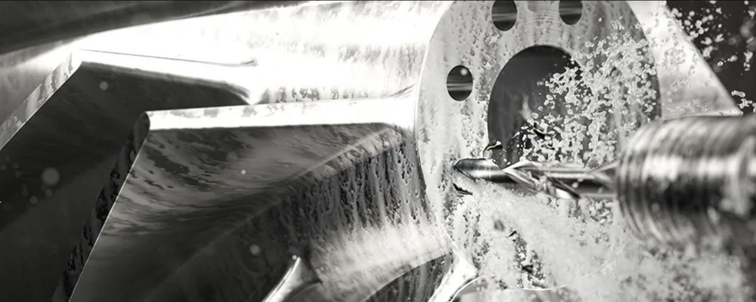 Una fotografía en blanco y negro de una máquina cortando un trozo de metal.