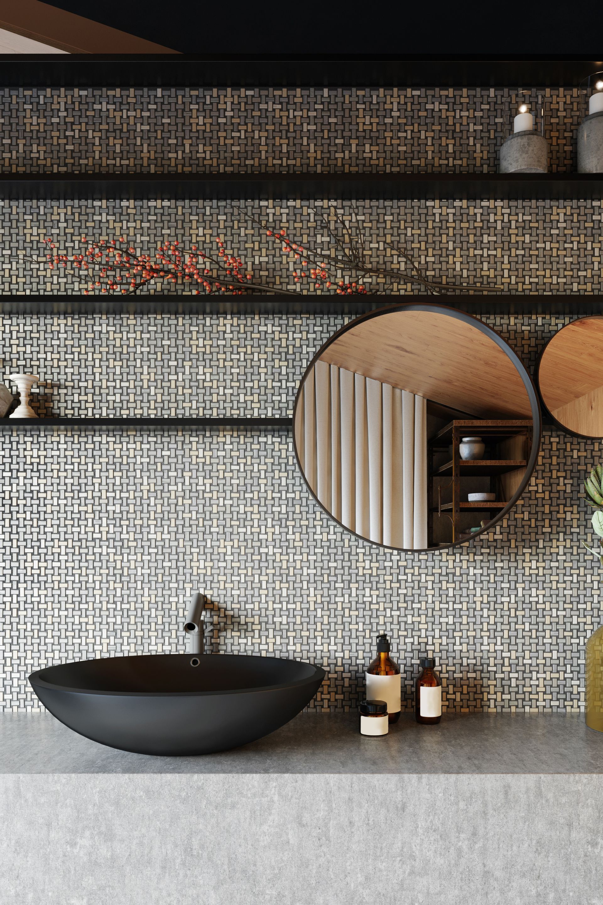 Meuble-lavabo moderne avec vasque noire, miroir rond, mur à motifs et flacons sur un comptoir gris.