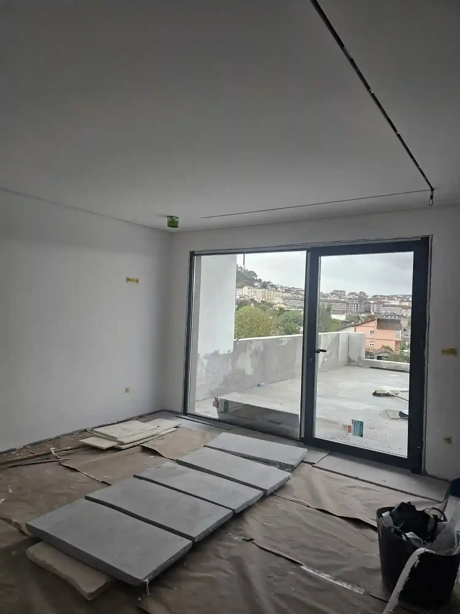 Habitación parcialmente terminada con grandes puertas corredizas de vidrio