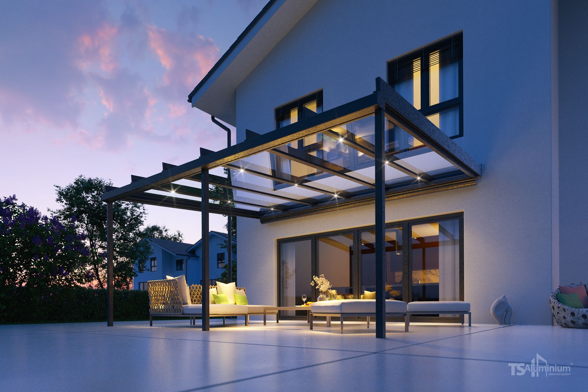 Ein Haus mit einer Pergola auf der Terrasse bei Nacht.