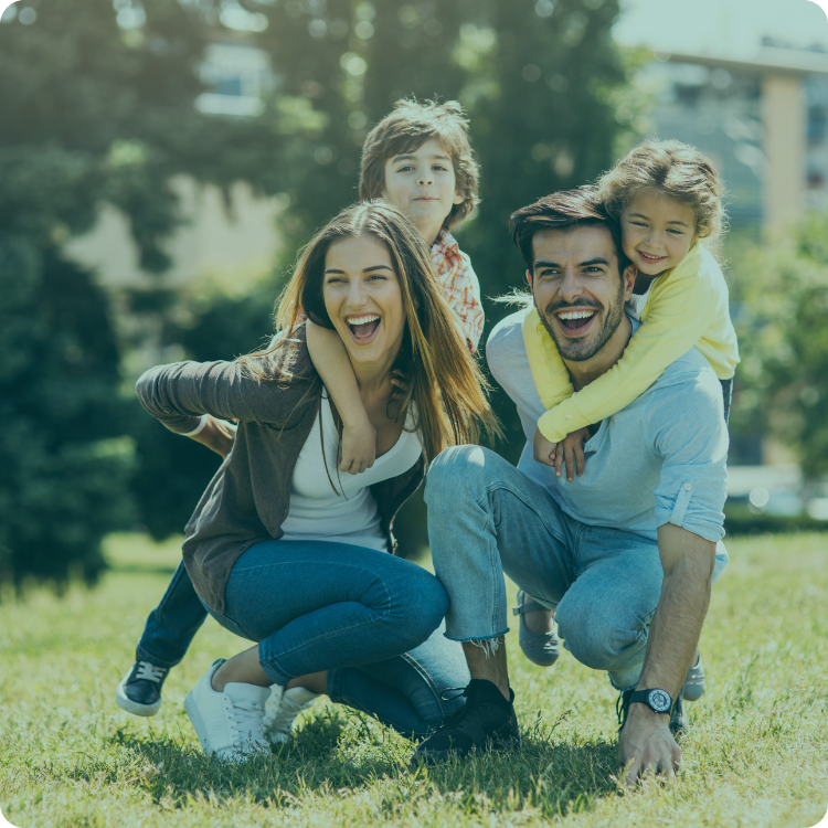A family is posing for a picture in a park.
