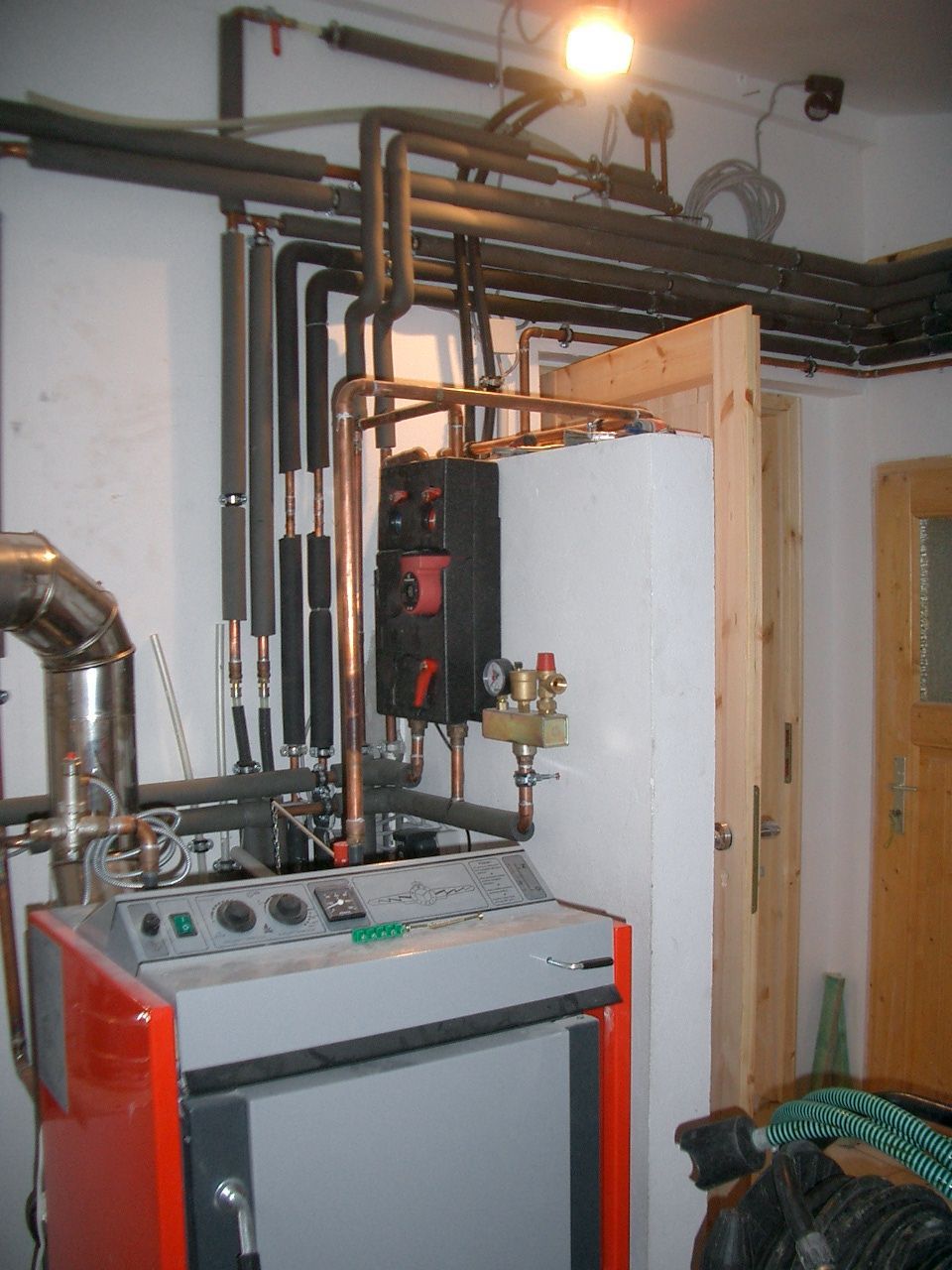 Ein Raum mit einer Heizung und Rohren an der Wand