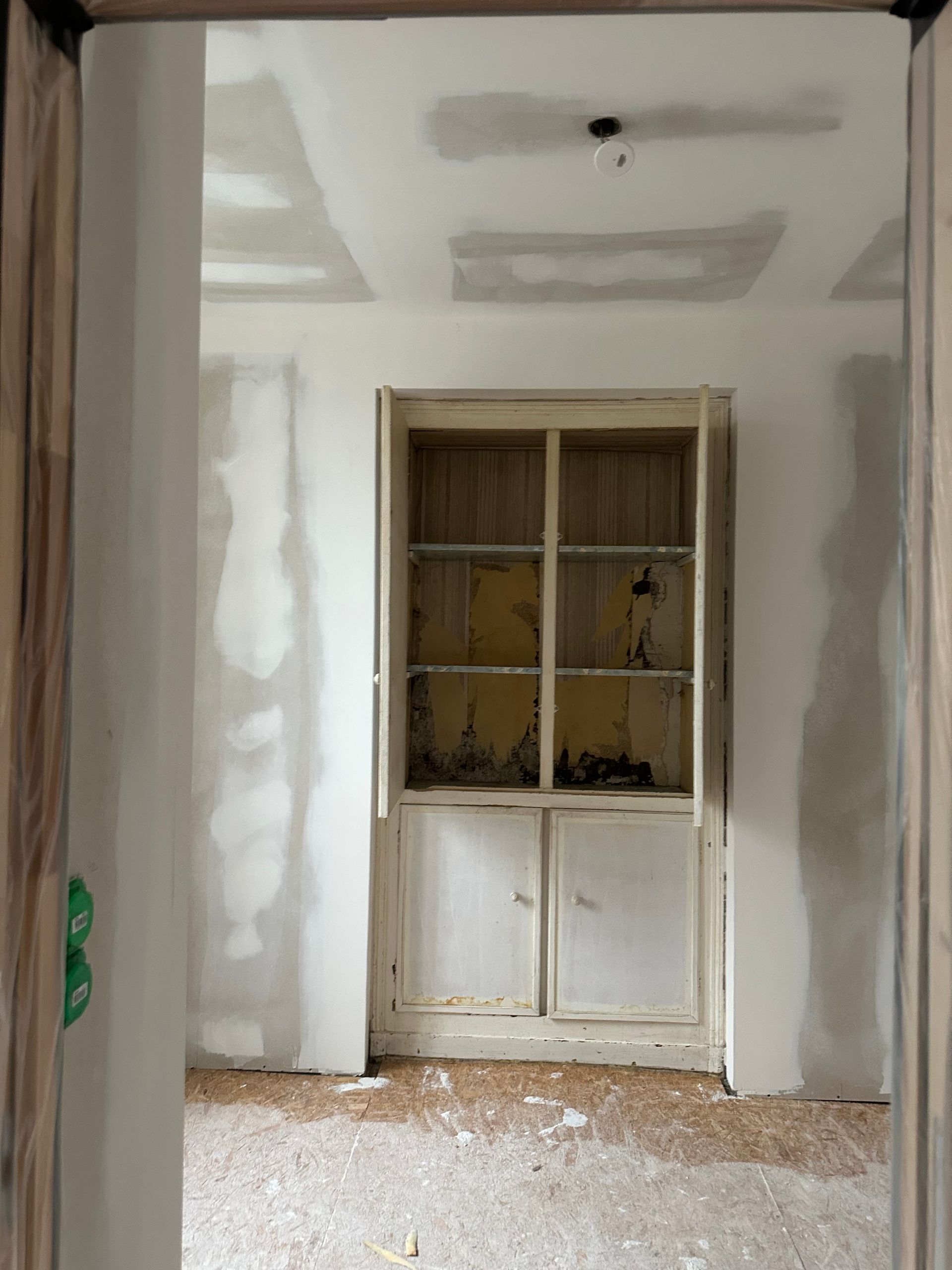 Pièce nue avec des murs, un plafond et une armoire contre le mur.