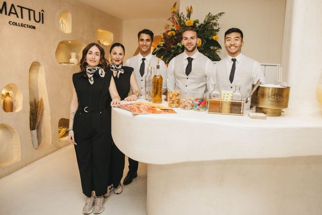 Tres cócteles: bebidas de color ámbar con hielo, guarniciones y rodajas de cítricos sobre una superficie blanca.