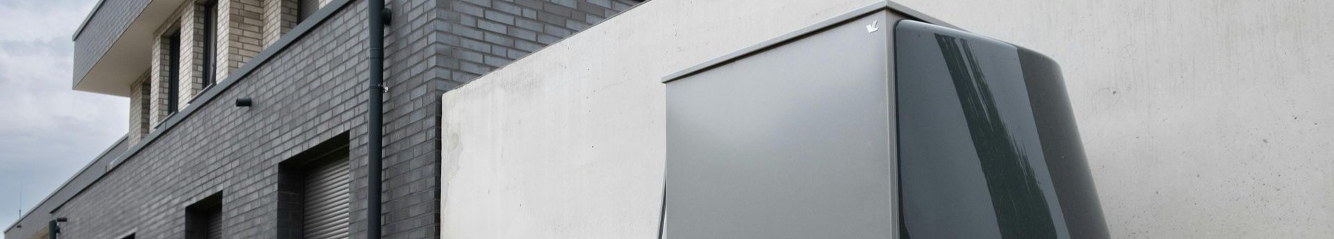 Eine Reihe von Solarmodulen und Windrädern mit einem Sonnenuntergang im Hintergrund.