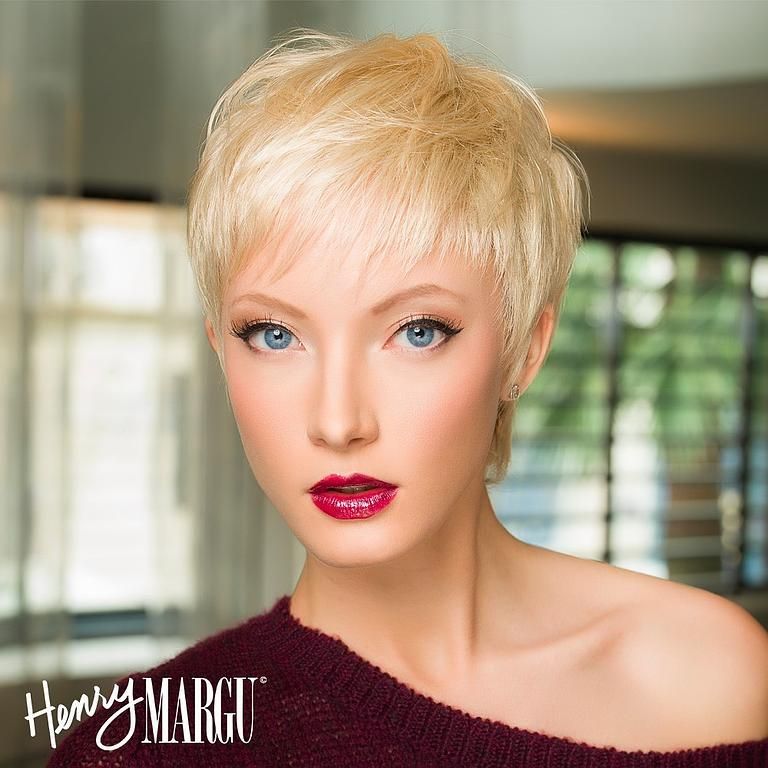 Personne blonde aux yeux bleus et au rouge à lèvres rouge foncé ; pose de profil.