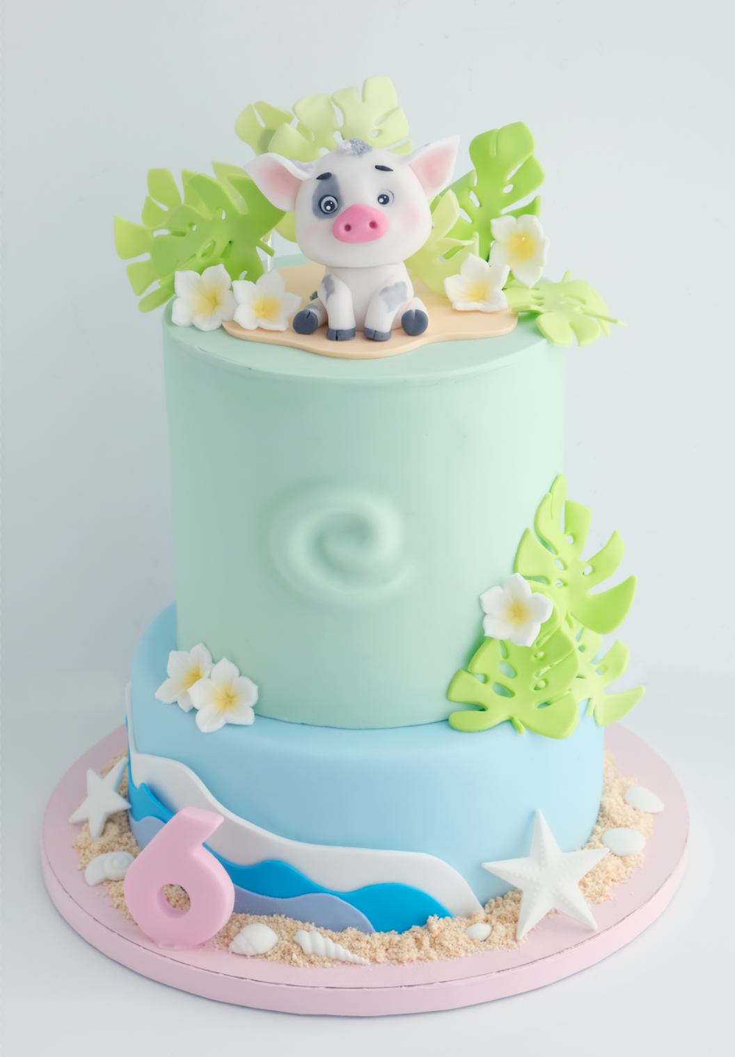 Un pastel de cumpleaños con un cerdo encima.