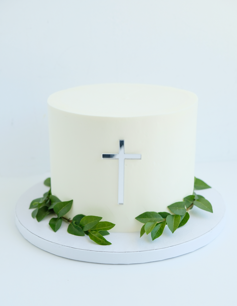 Un pastel blanco con una cruz encima