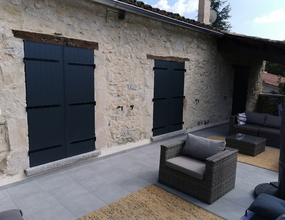 Deux grand volets noir fermés d'une maison 