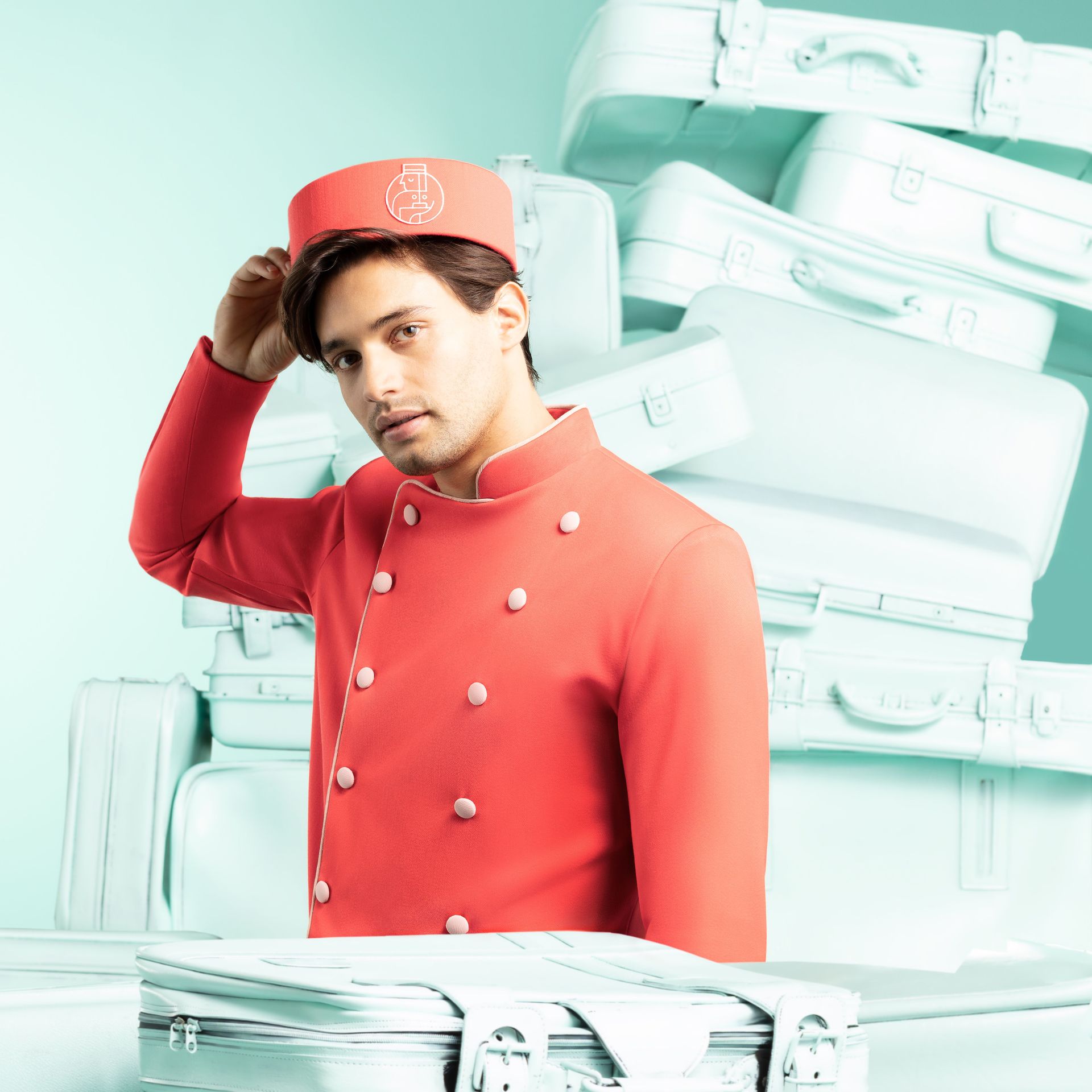 A man in a red uniform is standing in front of a pile of luggage
