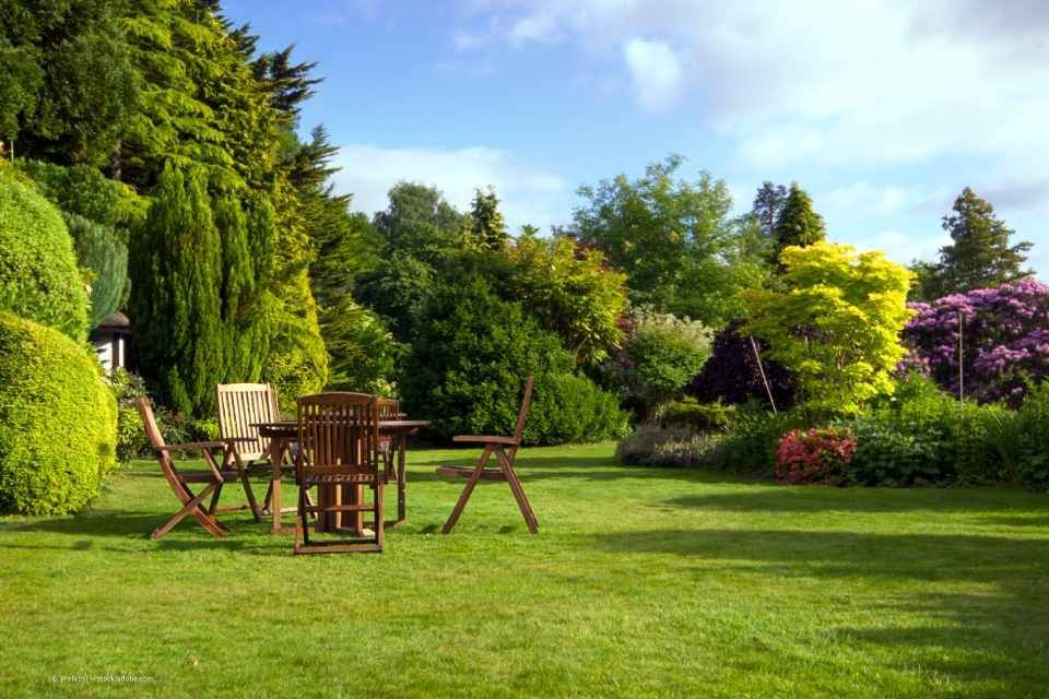 Garten mit großer Rasenfläche und Gartenmöbeln, angelegt von Sommer Garten- und Landschaftsbau