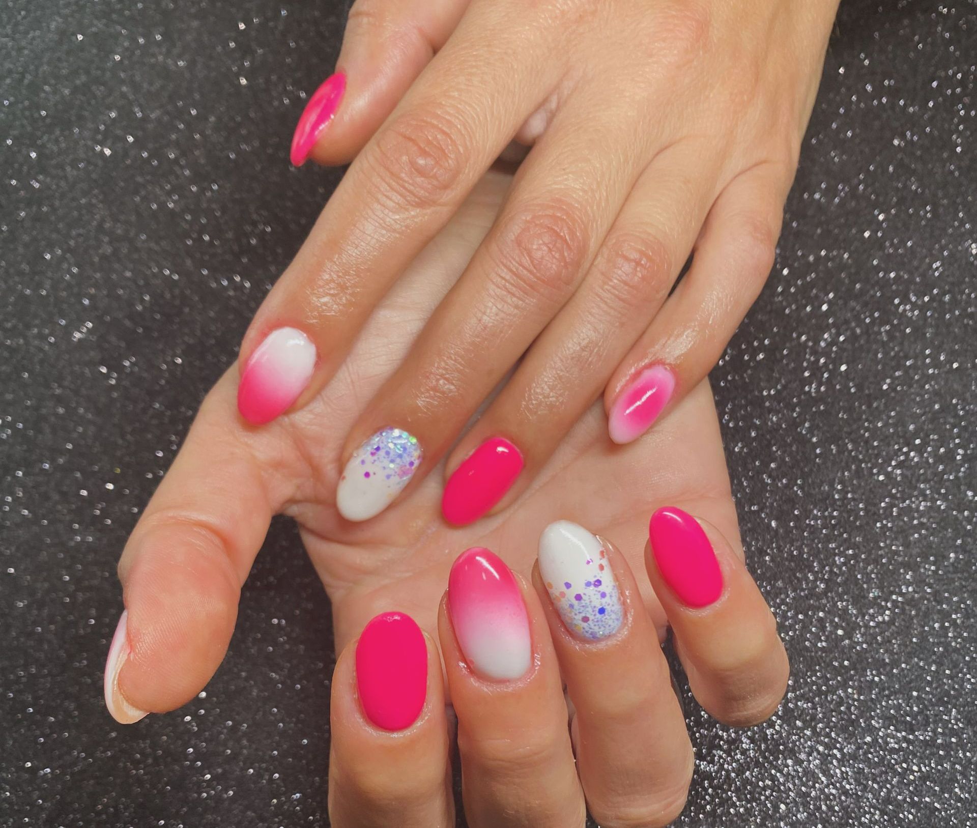 Les mains féminines avec la manucure rose.