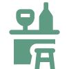 Un icono verde de una mesa con una botella y un taburete.