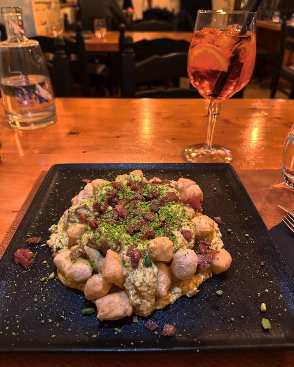 Une assiette de nourriture et un verre de vin sur une table