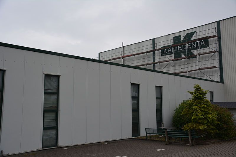 Ein weißes Gebäude mit einem Schild mit der Aufschrift „Kamilrenta“ darauf