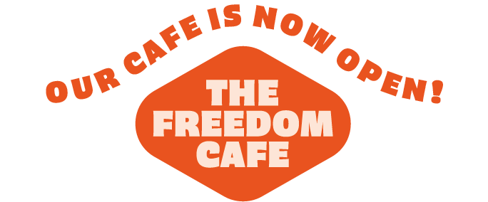 Orange logo reading “The Freedom Cafe” with “Our cafe is now open!” above it
