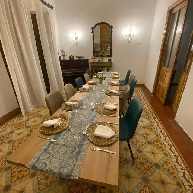 Un comedor con una mesa larga y sillas.