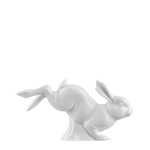 Ein weißes Porzellankaninchen springt nach oben.