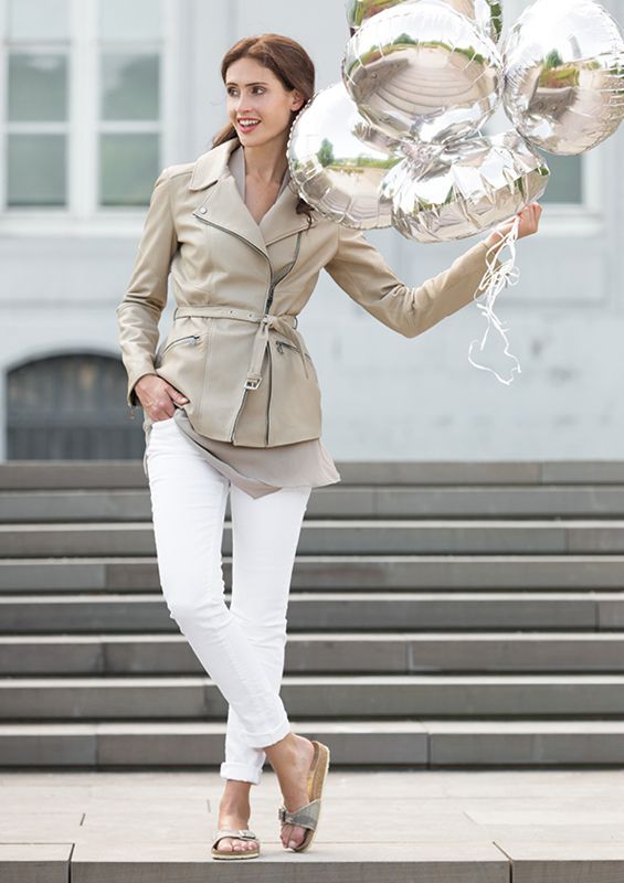Eine Frau steht auf einer Treppe und hält Luftballons.