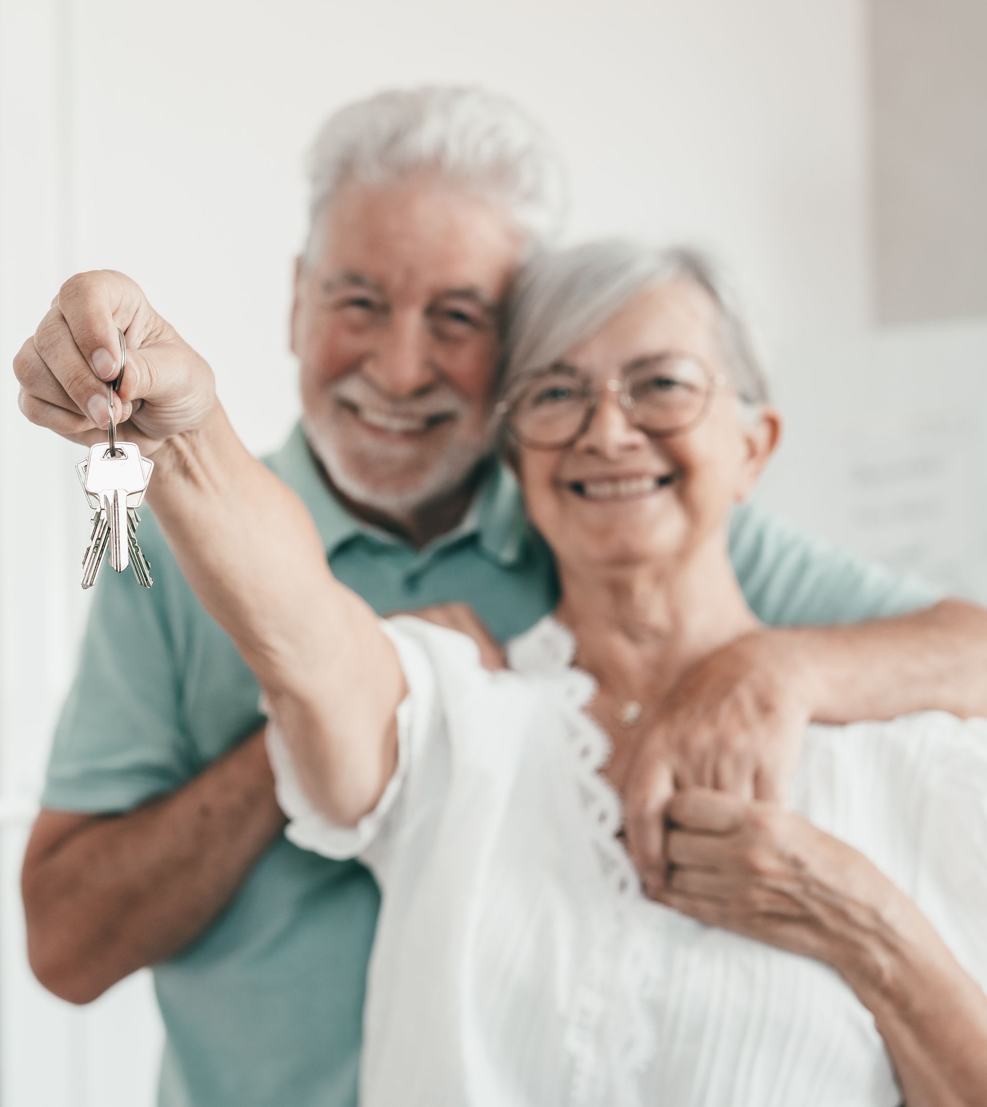 Ein Mann und eine Frau posieren für ein Foto, und die Frau hält einen Schlüssel