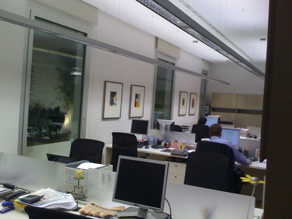 Un hombre se sienta en un escritorio con una computadora frente a él.