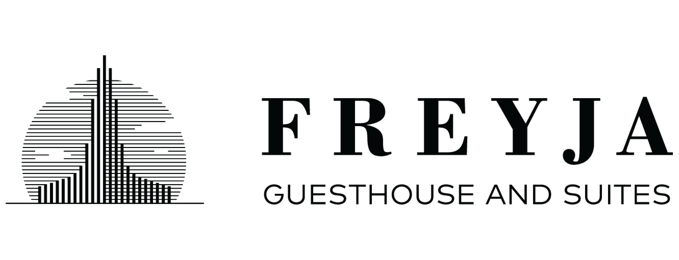 Logo for Freyja Guesthouse and Suites: a stylized tower inside a striped circle, above the name.