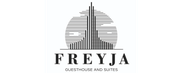 Logo for Freyja Guesthouse and Suites: a stylized tower inside a striped circle, above the name.