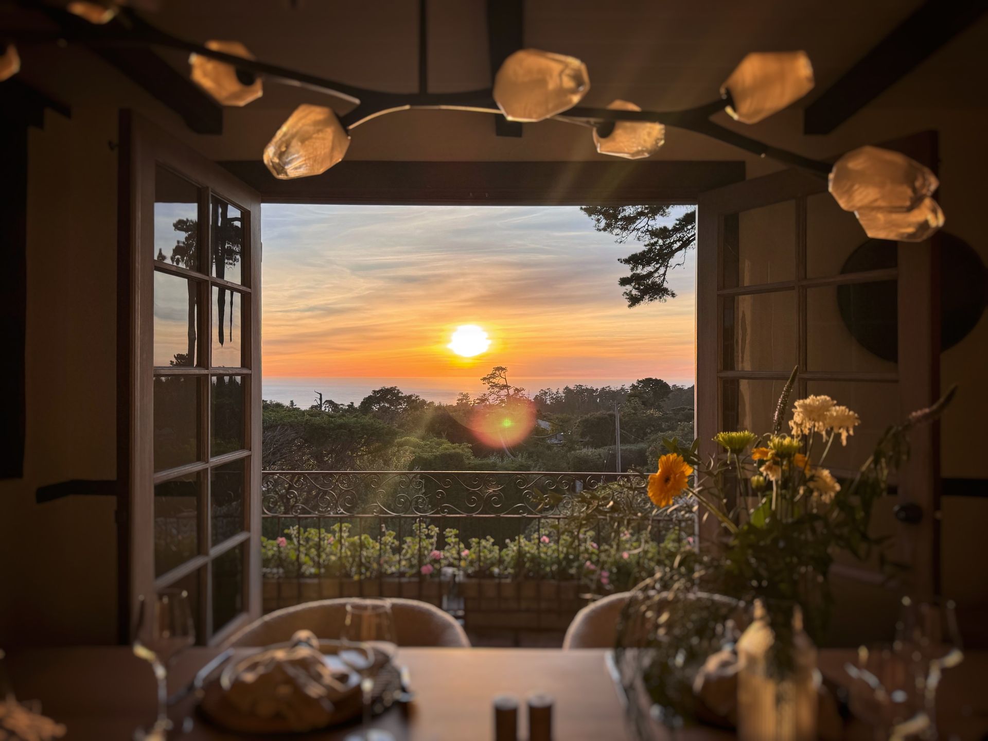 A dining room table with a view of the sunset