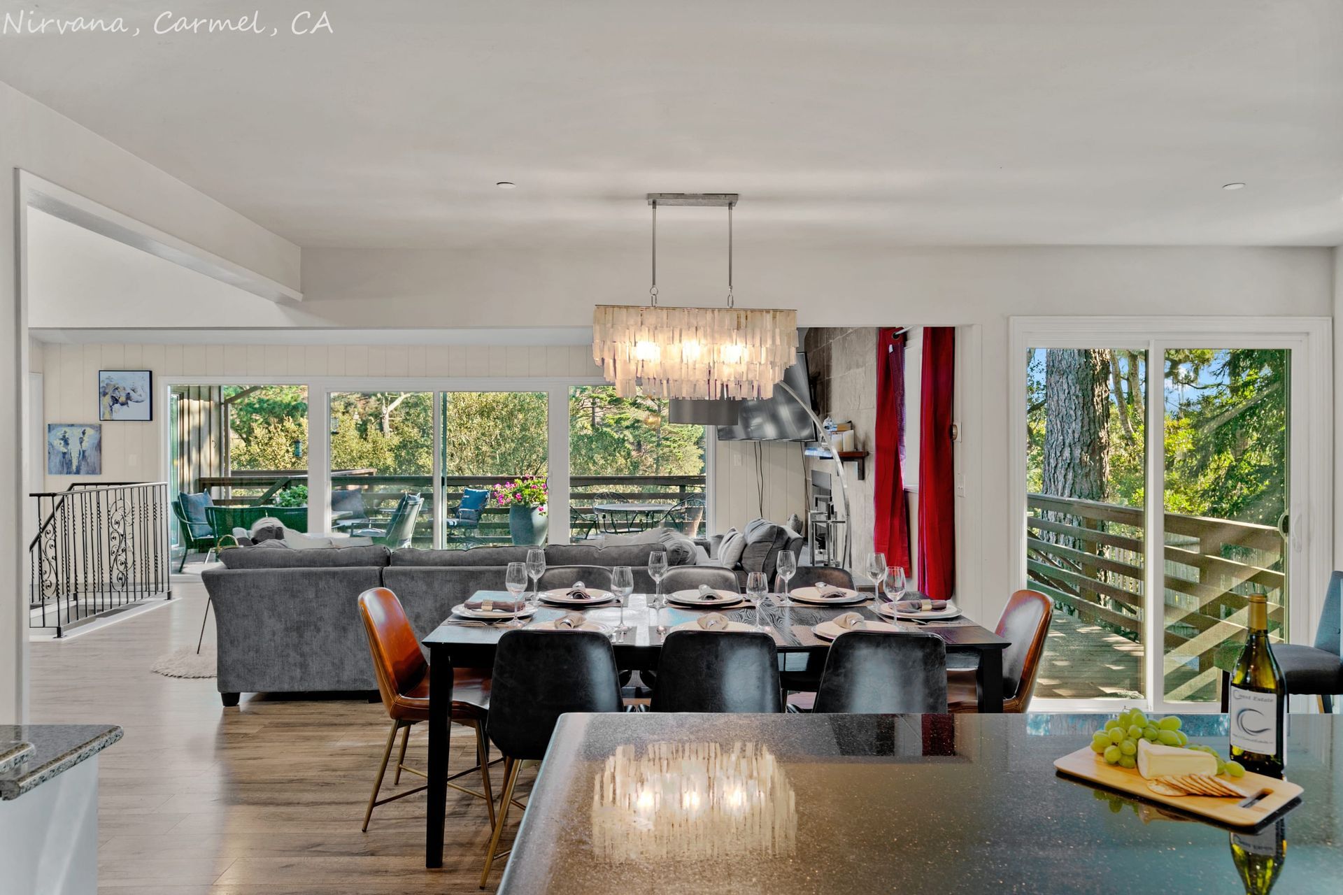 A dining room with a table and chairs and a chandelier