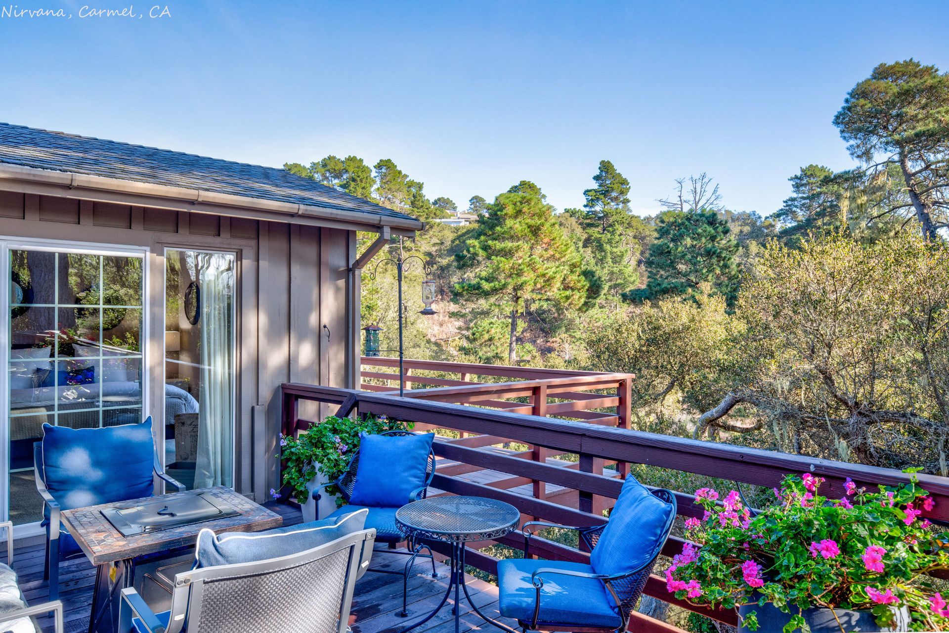 There is a balcony with a table and chairs on it.
