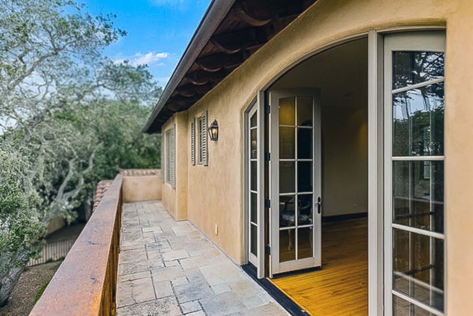 A large house with a balcony and french doors