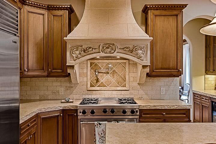 A kitchen with stainless steel appliances and wooden cabinets