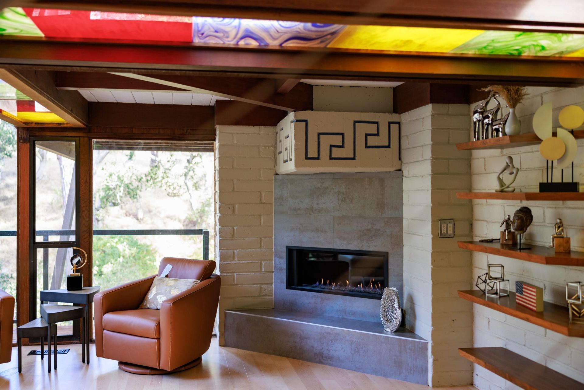A living room with a fireplace and a chair