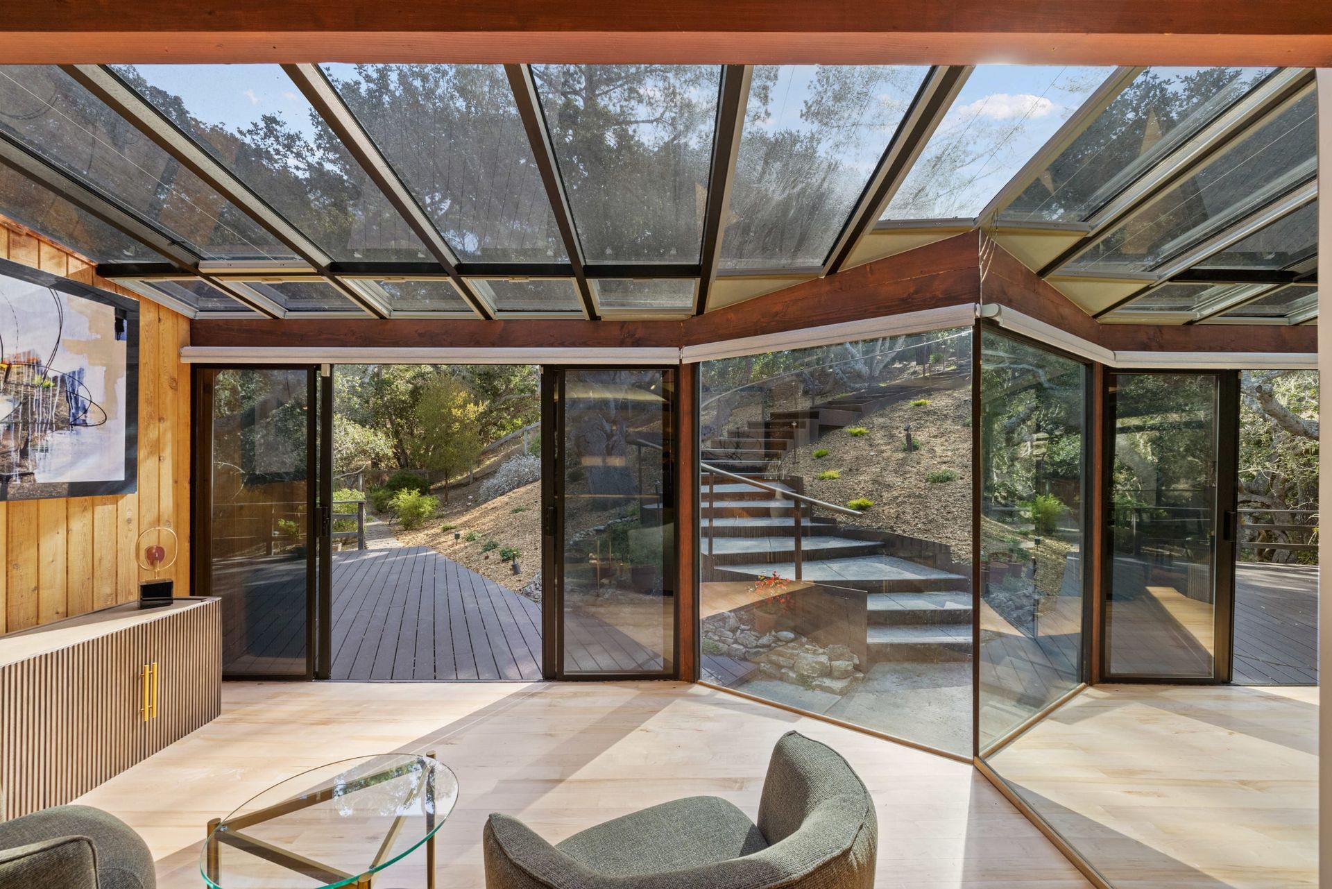A house with solar panels on the roof and stairs leading up to it