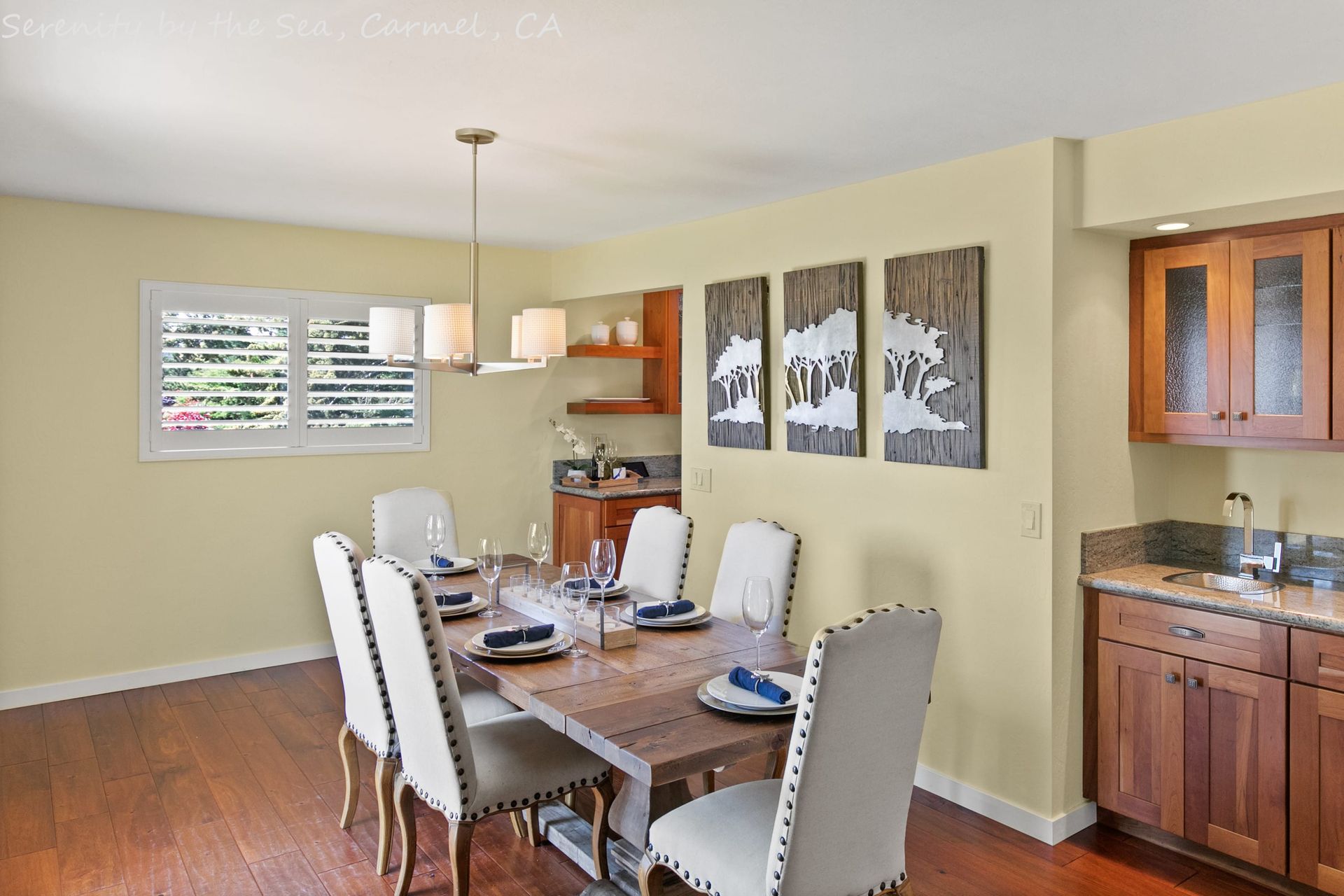A dining room with a table and chairs and a kitchen