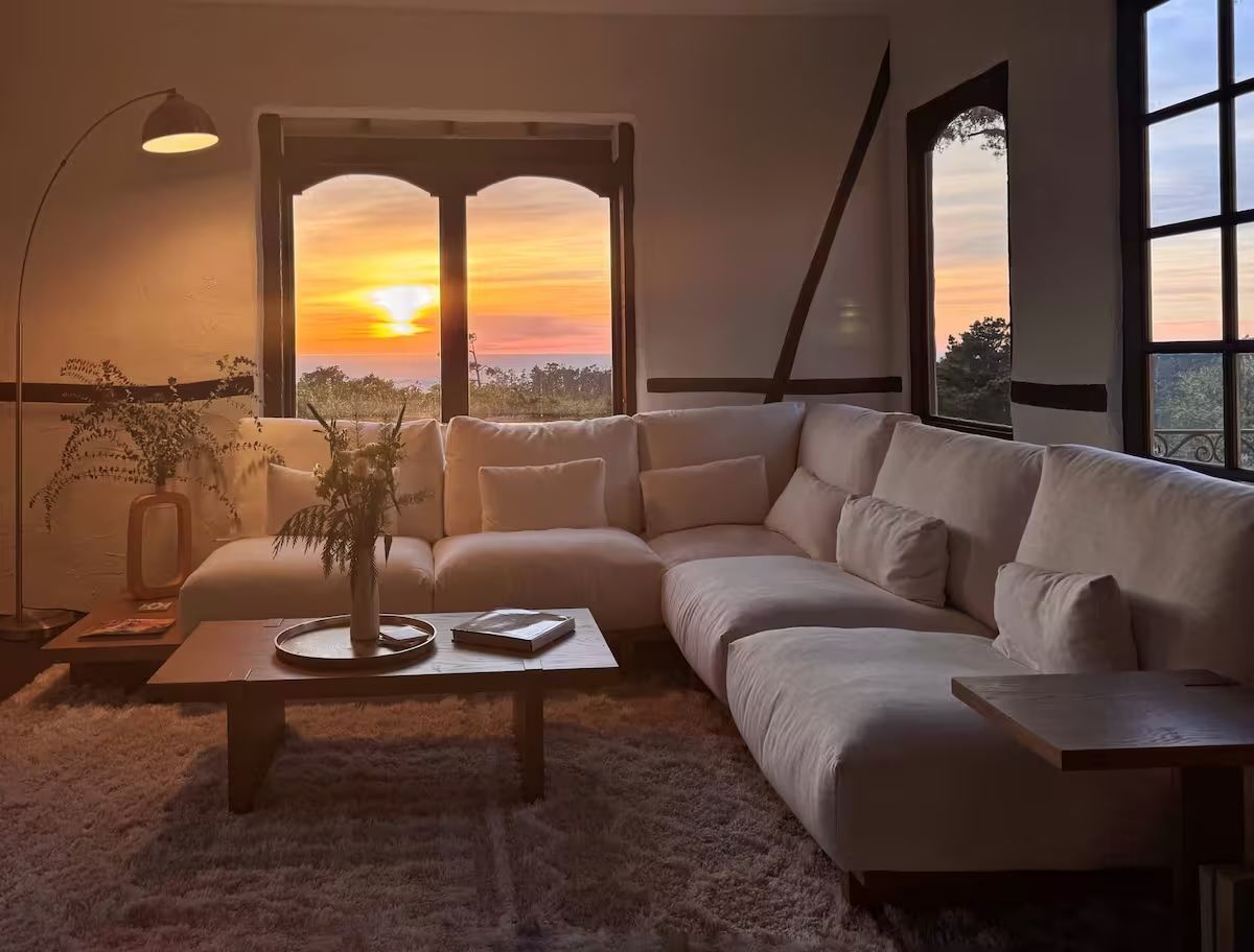 A living room with a large sectional couch and a coffee table