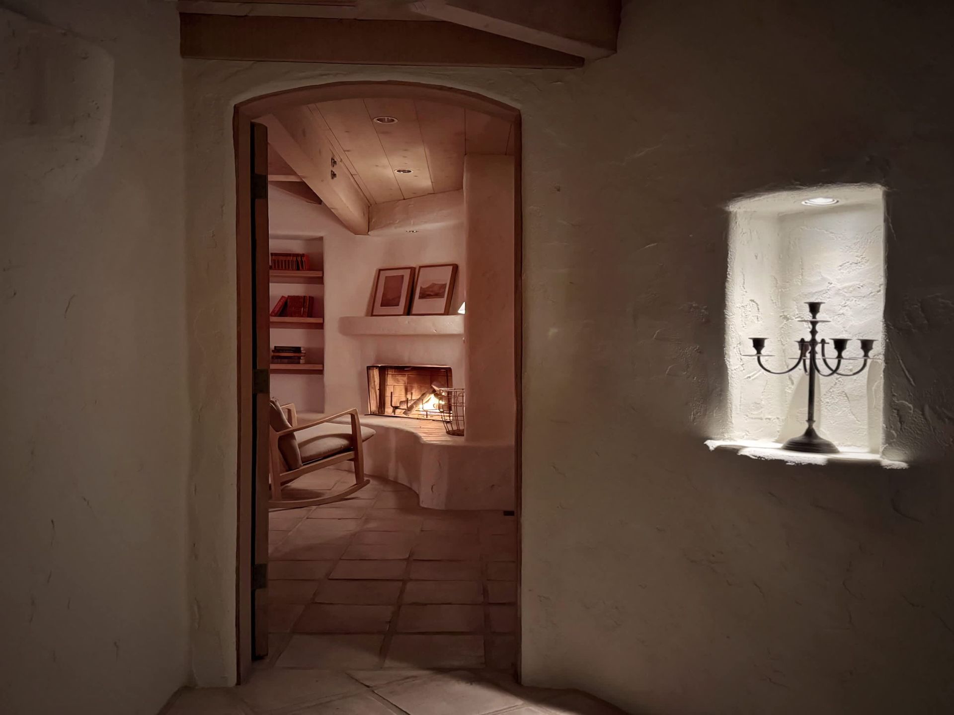 A room with a fireplace and a rocking chair in it