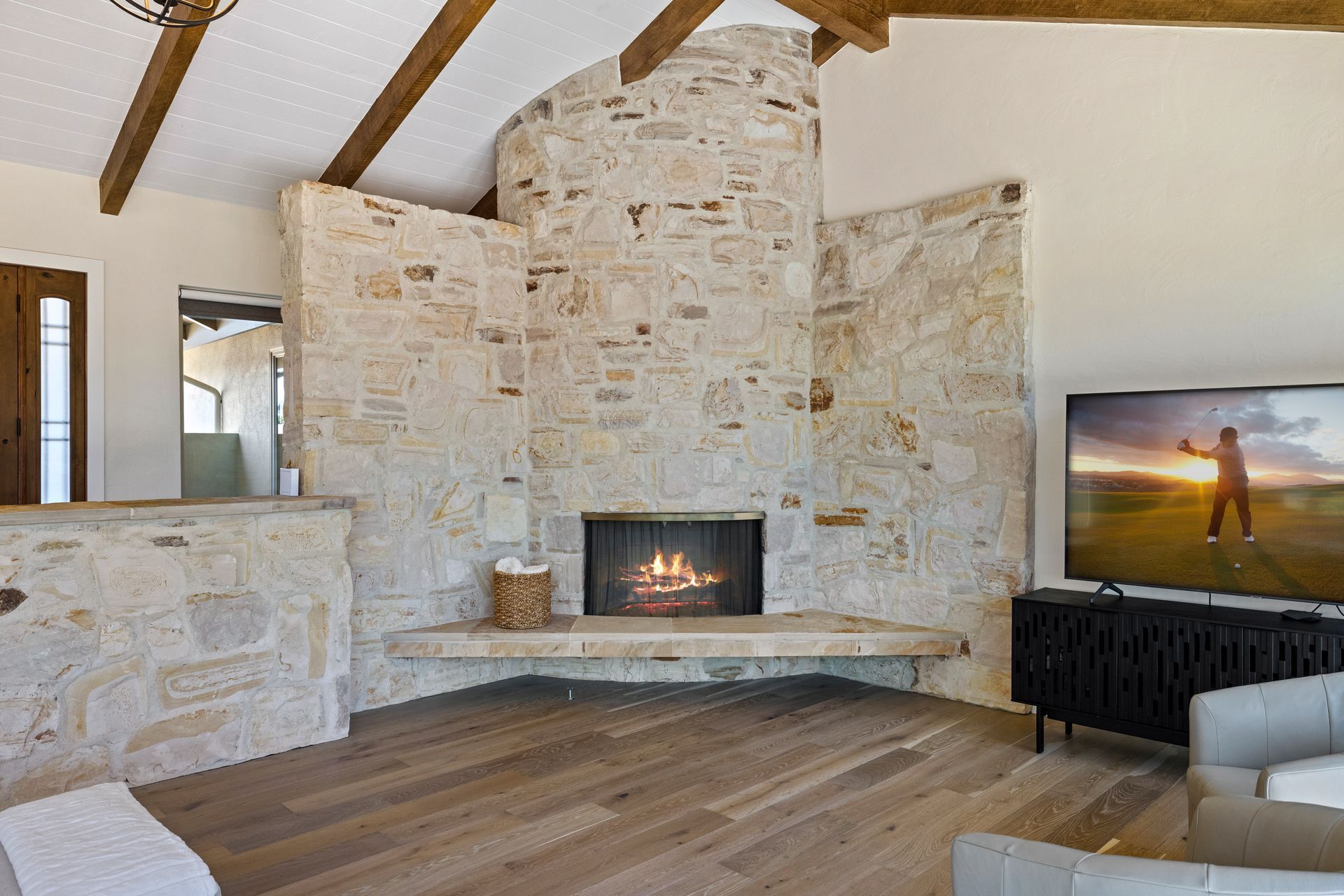 A living room with a fireplace and a flat screen tv.