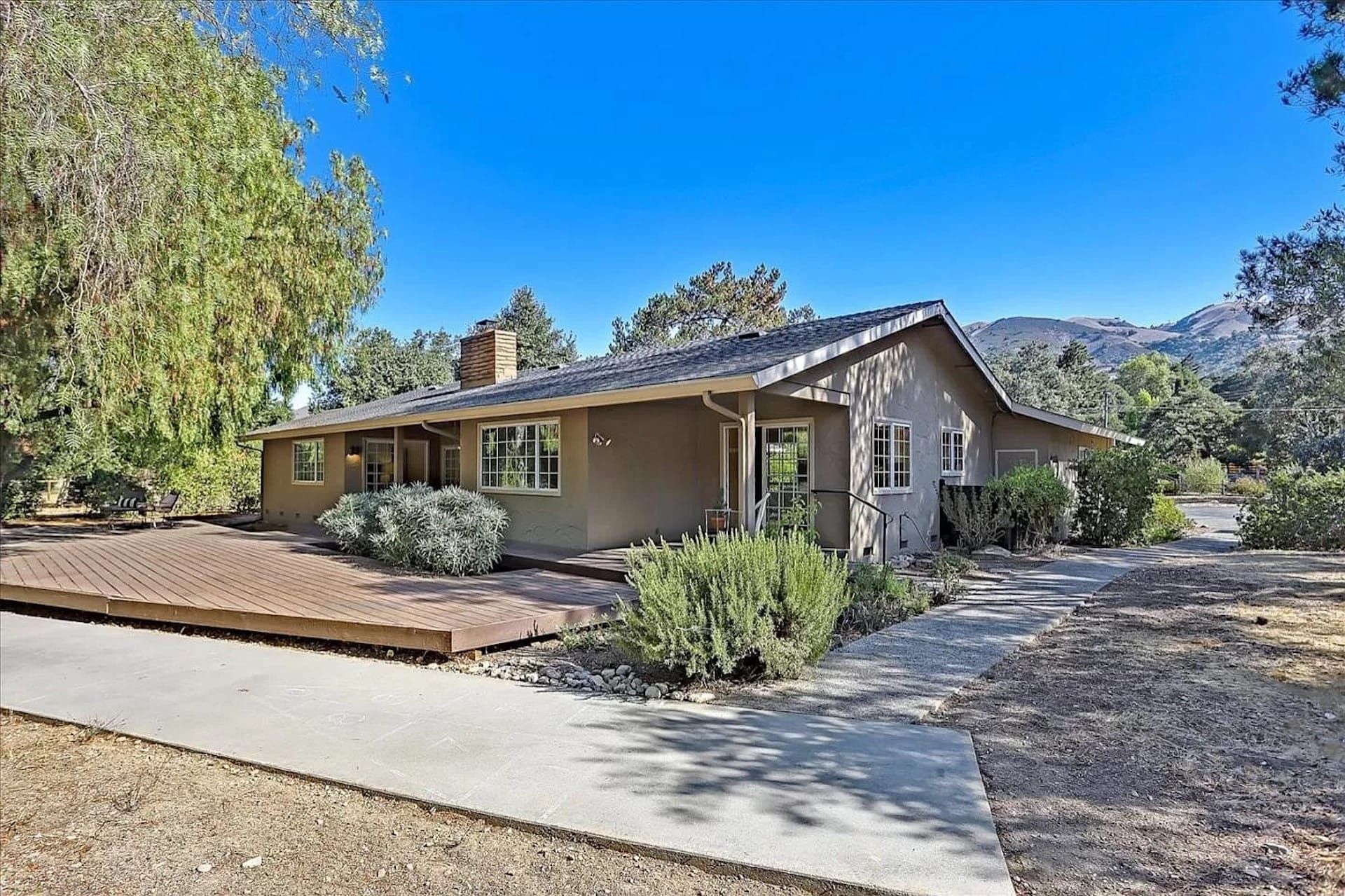 A house with a concrete walkway leading to it